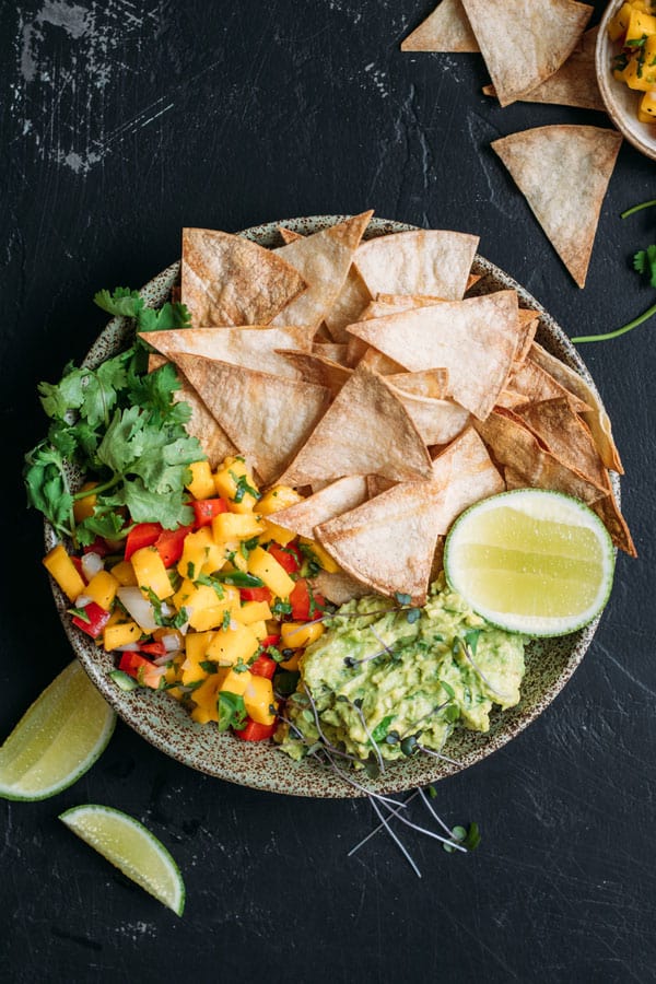 Baked corn chips with guacamole and mango salsa