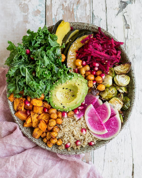 This healthy vegan fall harvest buddha bowl recipe is loaded with nourishing ingredients like sweet potato and chickpeas! Enjoy this healthy bowl for lunch or dinner!