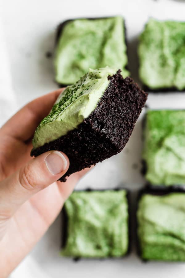 gluten free almond flour brownies with matcha frosting being held