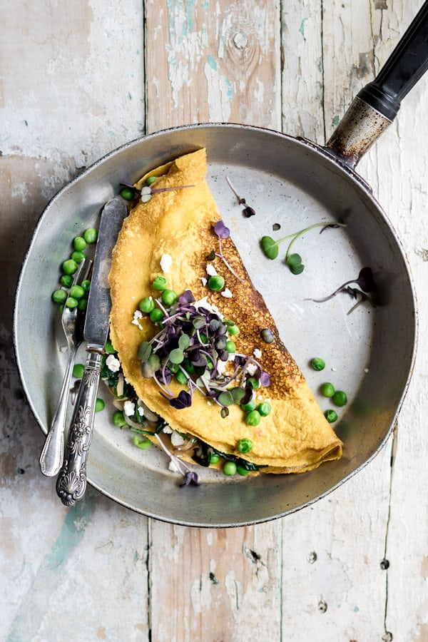 vegan and gluten free omelette made with chickpeas in skillet with knife and fork