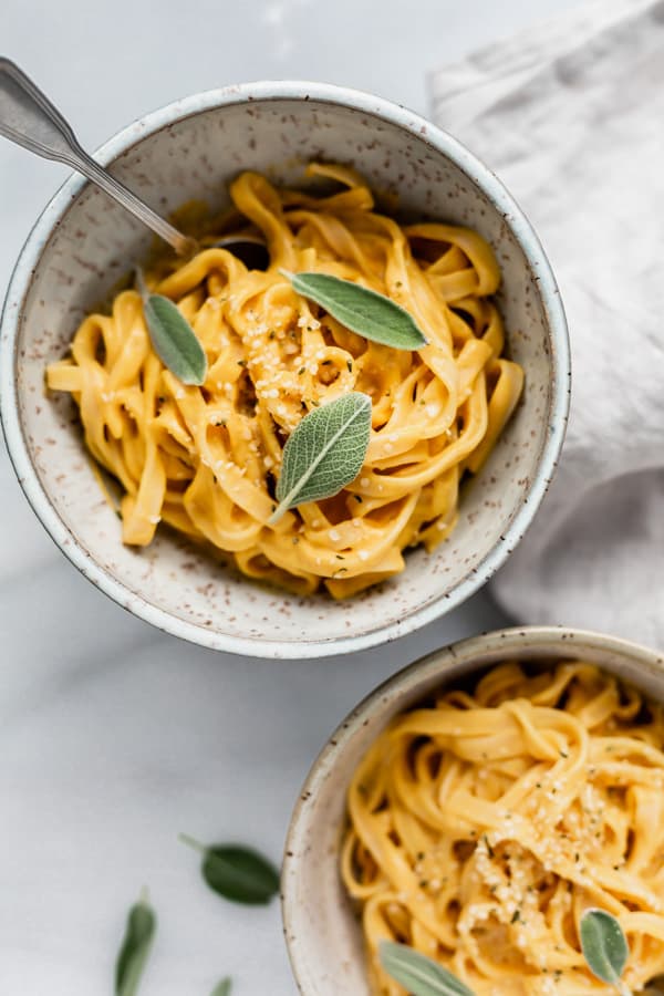 Vegan Pumpkin Alfredo Pasta in a ligh blue speckeld bowl