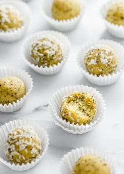 Lemon poppy seed bliss balls on a marble board