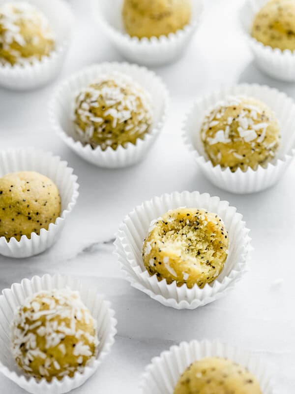 Lemon poppy seed bliss balls on a marble board
