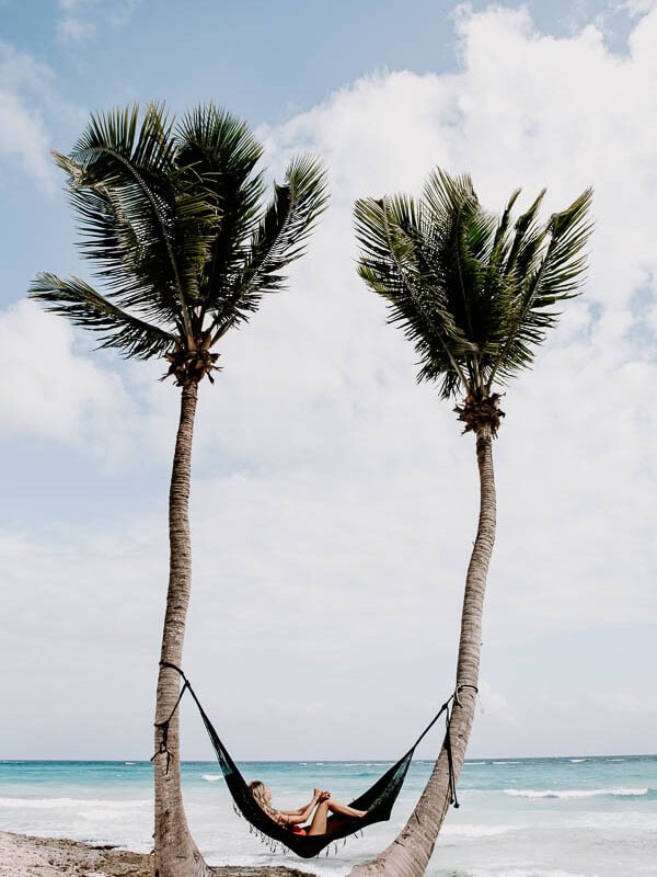 lounging in a hammock on the beach in Tulum mexico