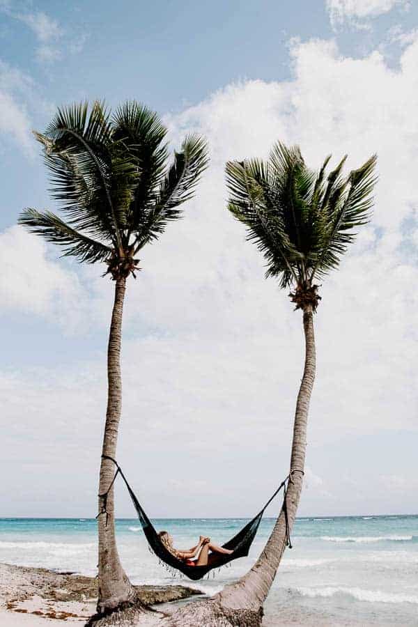 lounging in a hammock on the beach in Tulum mexico