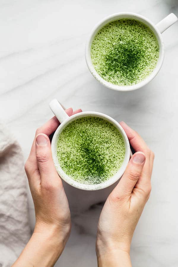 mugs filled with a matcha tea latte
