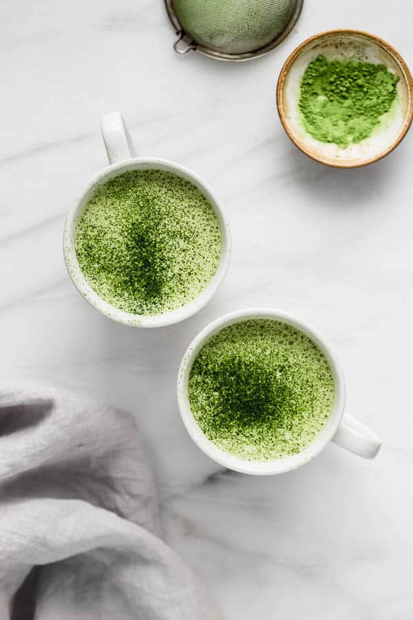 mugs filled with a matcha tea latte