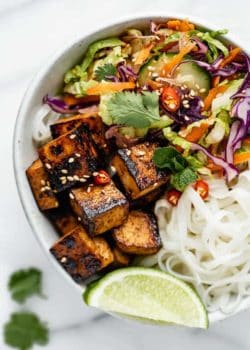 a bowl filled with Vietnamese salad, rice noodles and lemongrass tofu