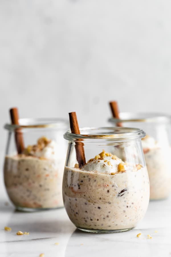 3 little cups of carrot cake overnight oatmeal topped with yogurt and walnuts.