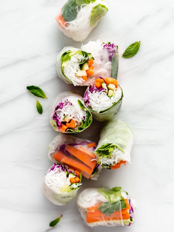 cut up rice paper rolls on a marble board