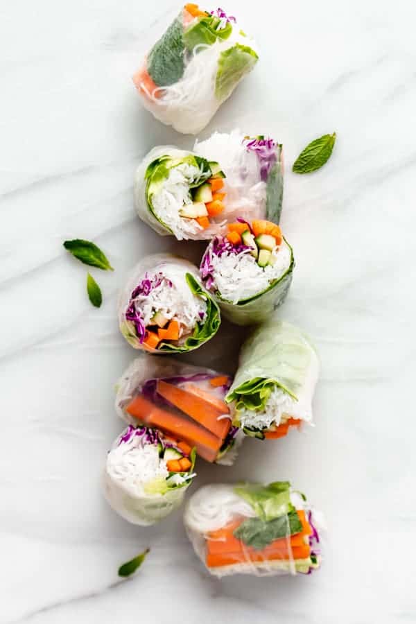 cut up rice paper rolls on a marble board