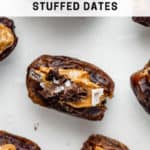 dates with almond butter and chocolate on a marble board