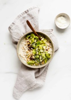 a bowl of bircher muesli on a grey napkin