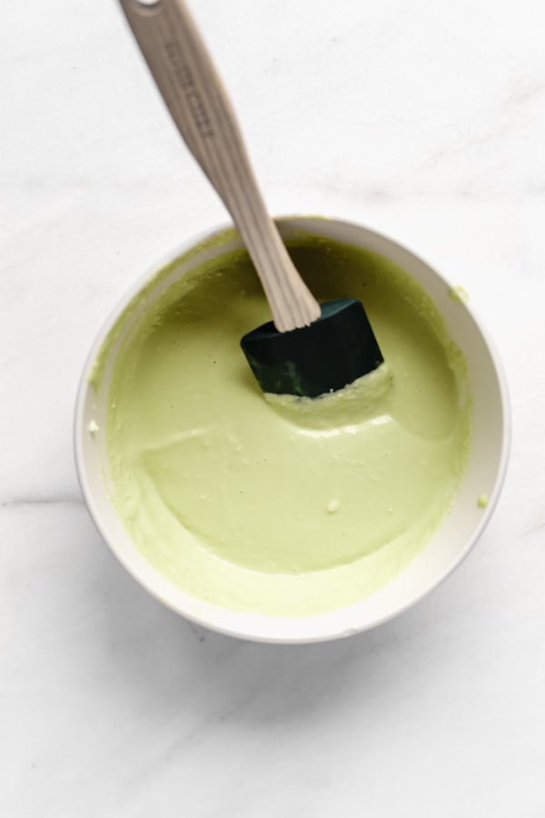 key lime mousse in a bowl with a spatula