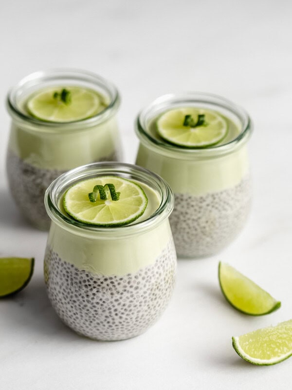 3 jars of key lime chia pudding with lime wedges on the side