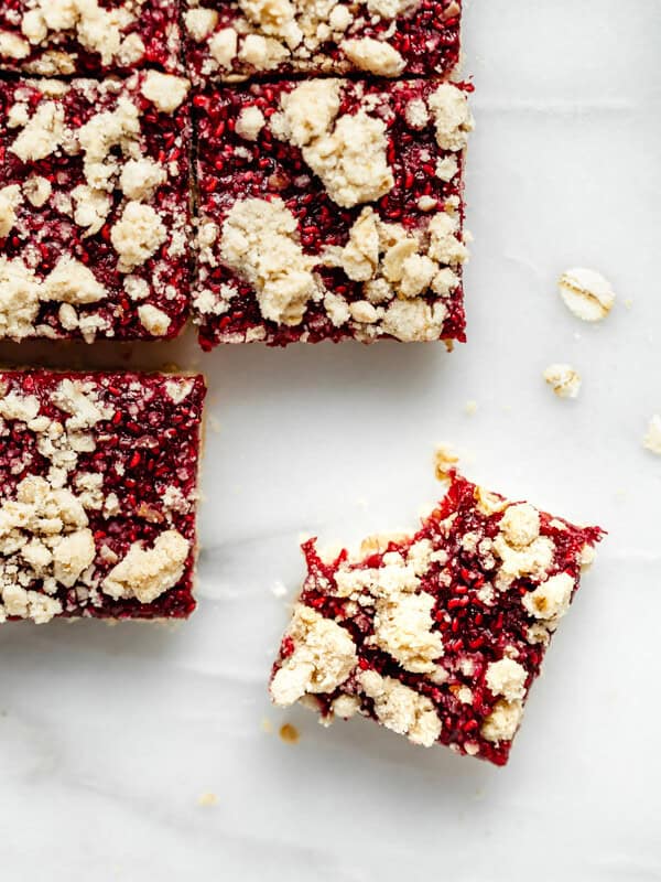 raspberry crumble bar with a bite taken out of it