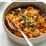 spaghetti squash in a bowl with sun-dried tomatoes