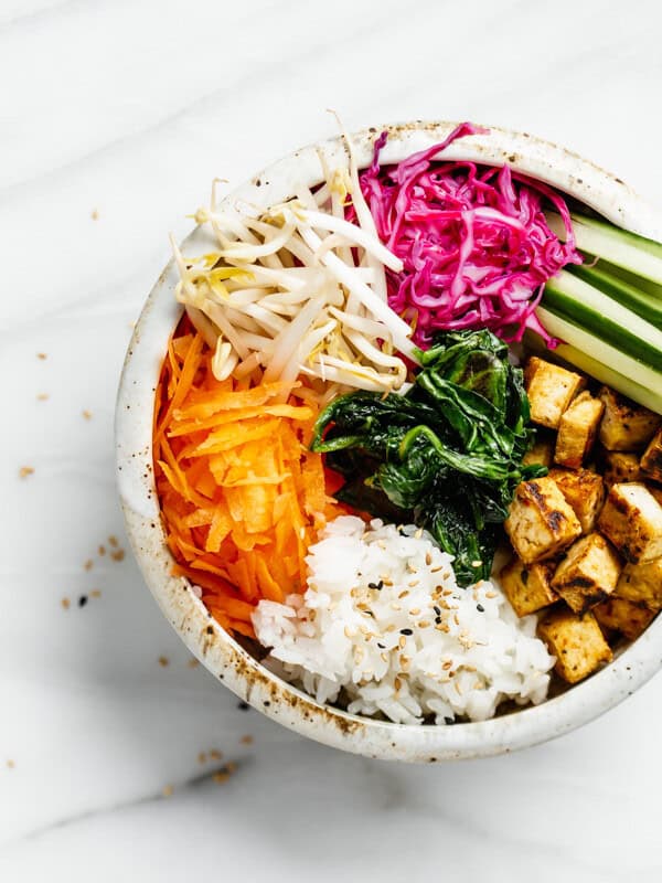 a bowl with carrots, rice, tofu and vegetables