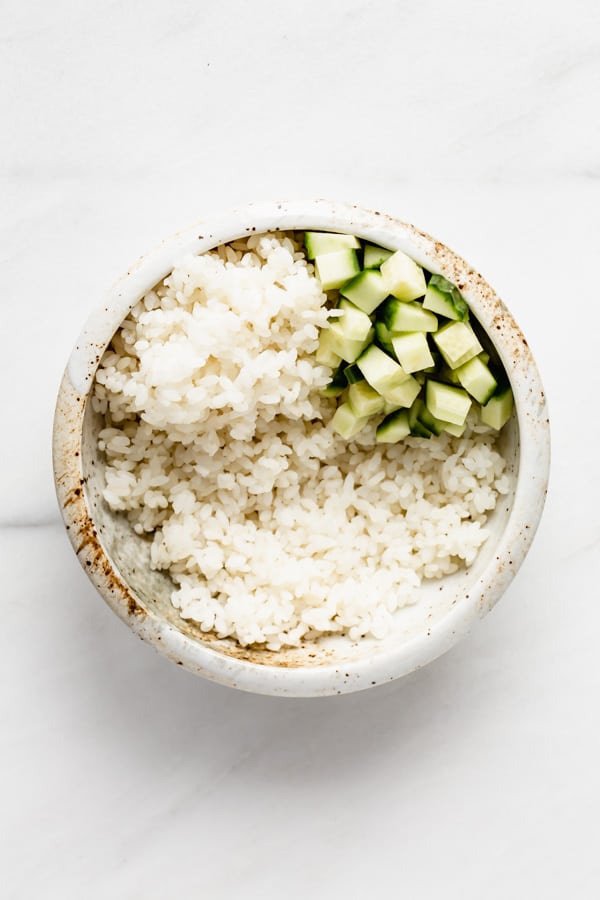 a bowl of rice with cucumber