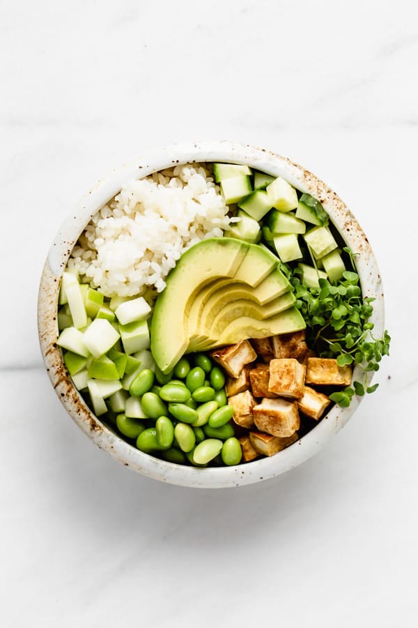 poke bowl with tofu avocado and green vegetables