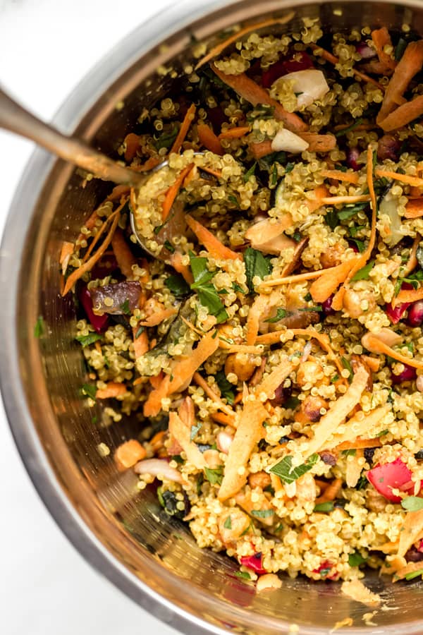 a close-up photo of Moroccan quinoa salad in a large metal bowl