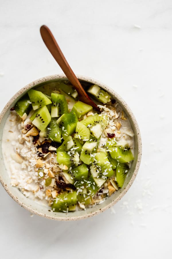 a bowl of bircher muesli with a wood spoon in it