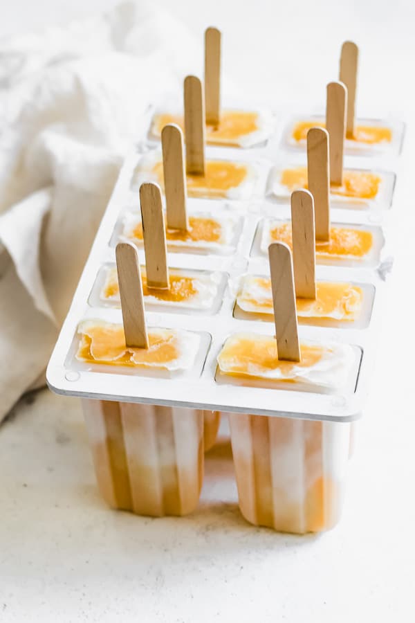 a popsicle mould with frozen popsicles in it