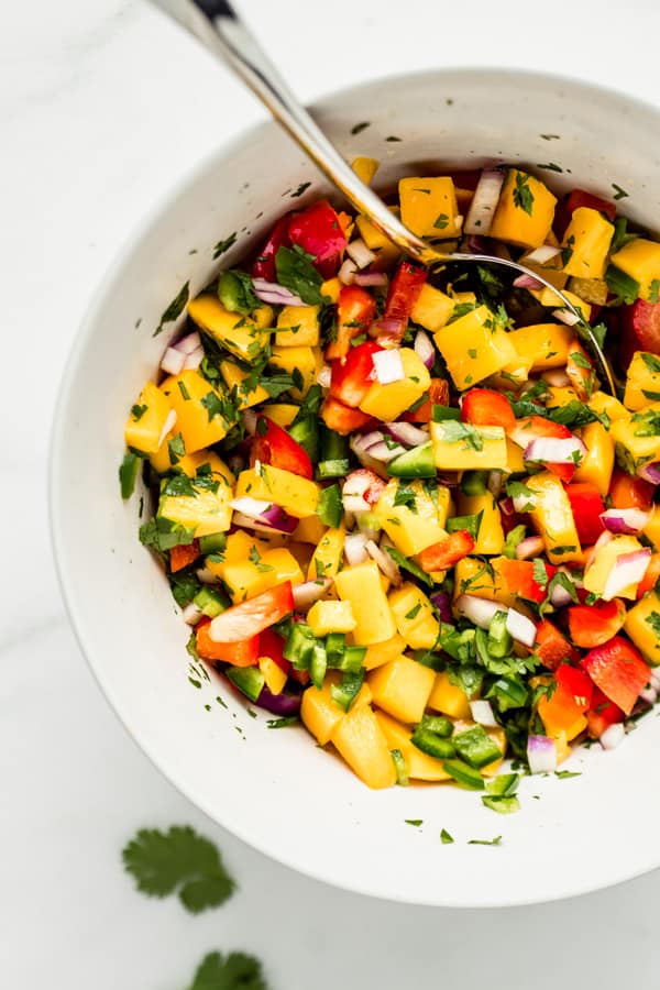 a mixing bowl with mango salsa