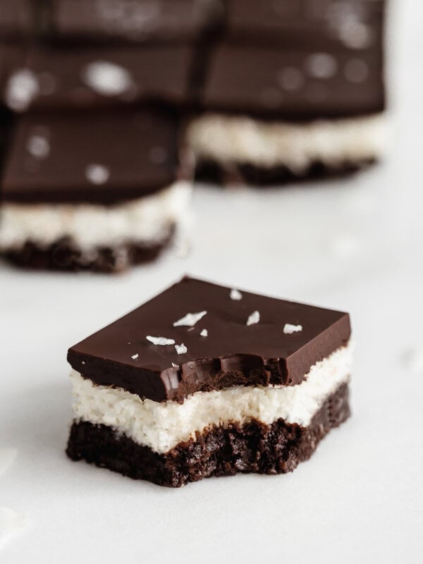 a no bake coconut brownie with a bite taken out of it