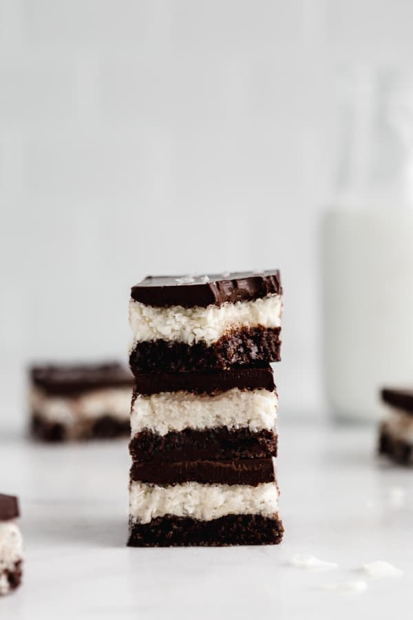 a stack of three no bake coconut brownies