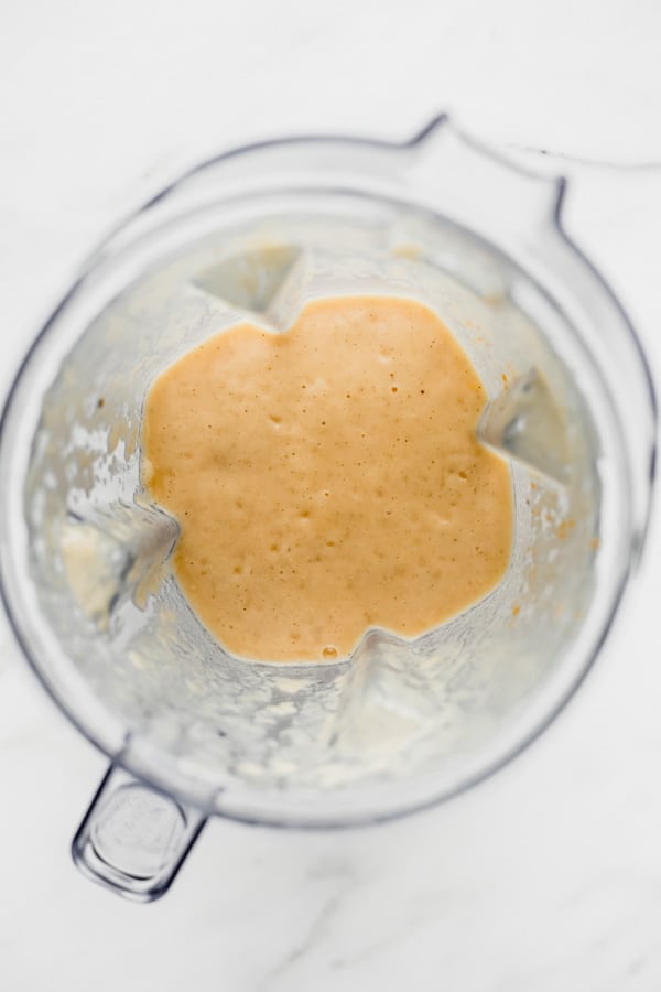 a blender with papaya smoothie in it