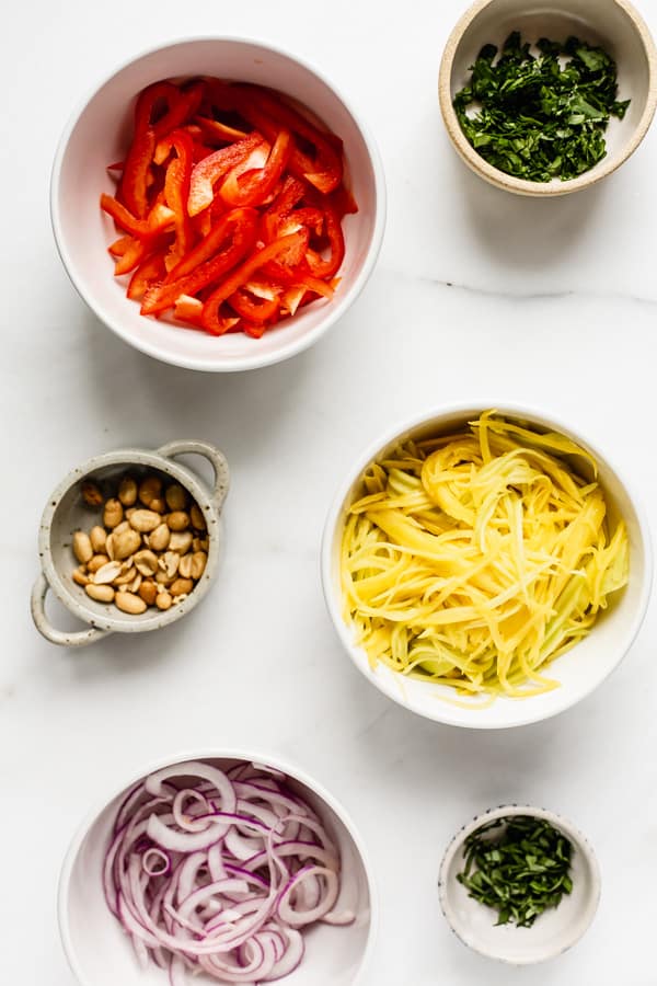 mango salad ingredients in individual bowls