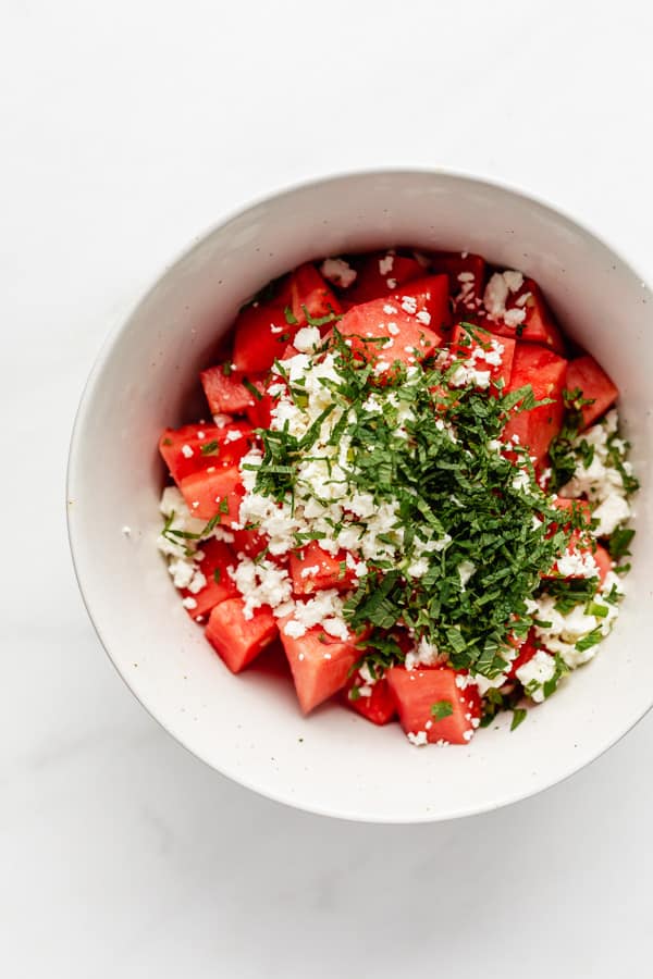 watermelon, feta and mint in a mixing bowl