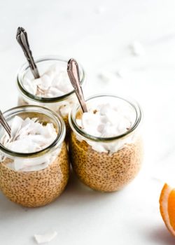 3 jars of creamsicle chia pudding with spoons and shredded coconut in them