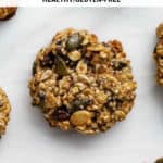 a breakfast cookie with nuts and seeds in it on a marble board