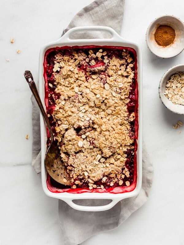 a strawberry rhubarb crisp in a white baking dish