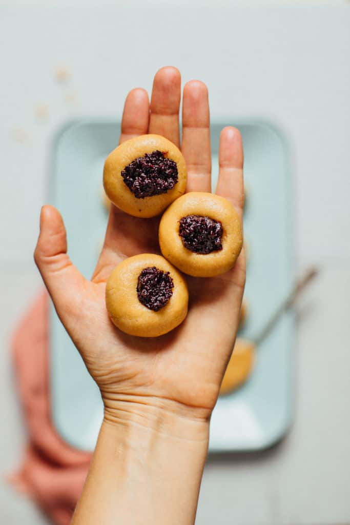 a hand holding 3 cookies