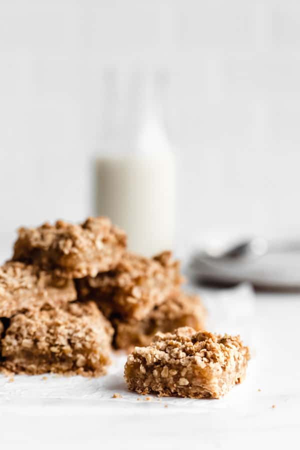 Apple pie bars cut into squares stacked on top of each other