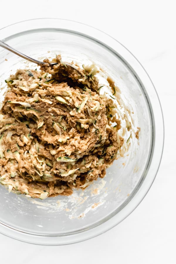 zucchini bread batter in a clear mixing bowl
