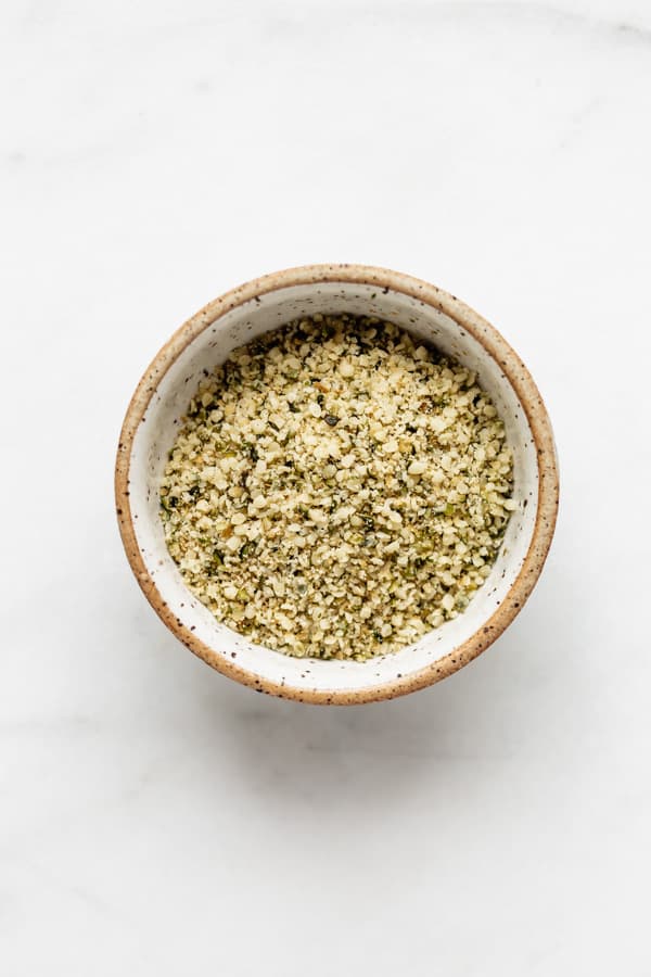 a small ceramic bowl with hemp seed parmesan in it