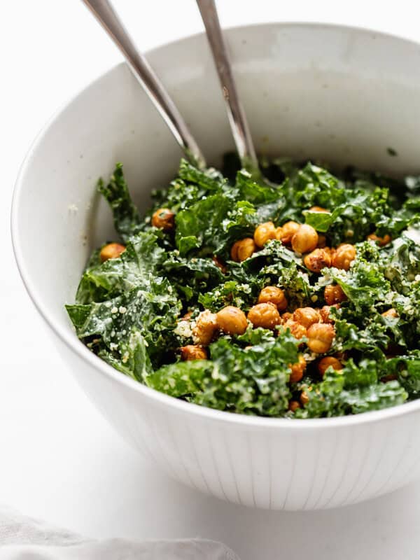 a serving bowl of kale Caesar salad topped with crispy chickpeas