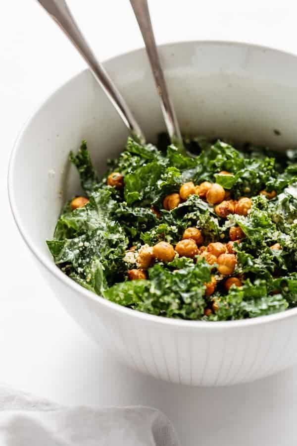 a serving bowl of kale Caesar salad topped with crispy chickpeas