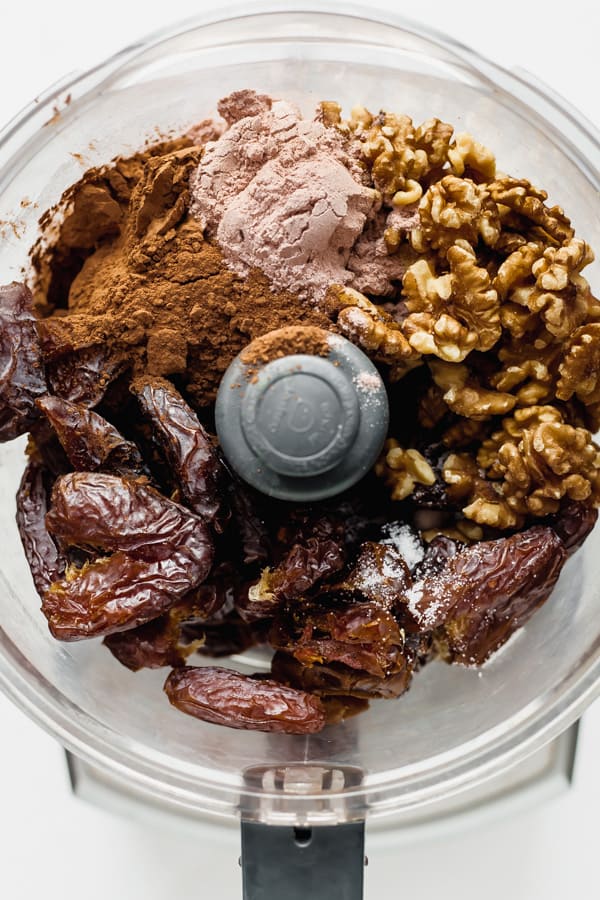a food processor with ingredients for no bake brownies in it