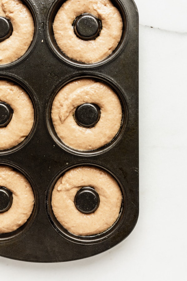 unbaked donuts in a donut pan