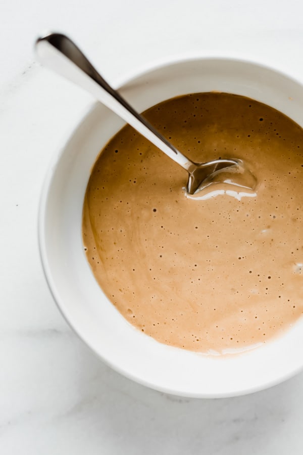 a white bowl with vegan vanilla pudding in it