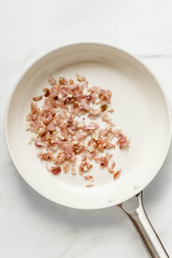 shallots and onions in a white pan