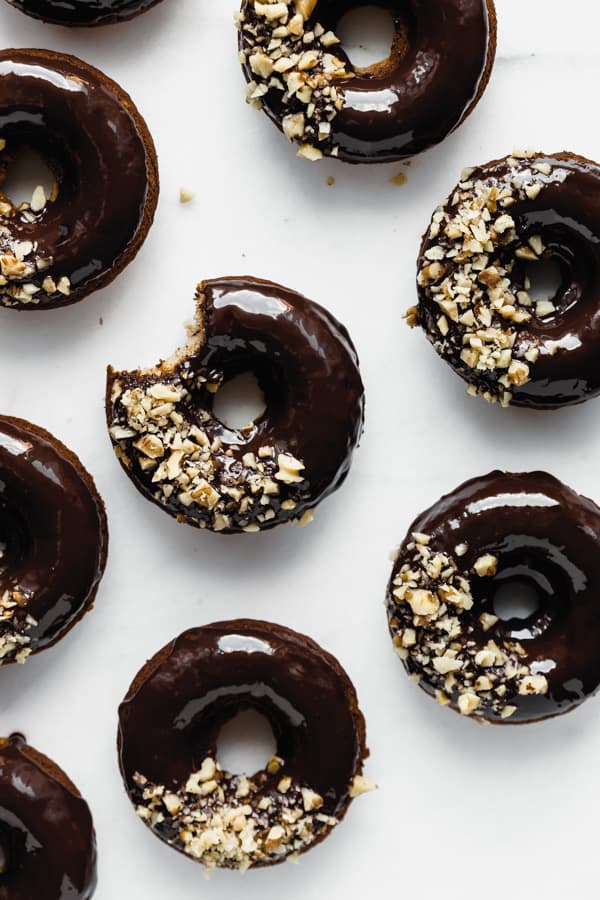 banana donuts with chocolate glaze on a white background