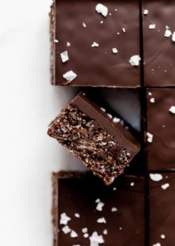 Rice Krispie treats cut in squares topped with flaked sea salt
