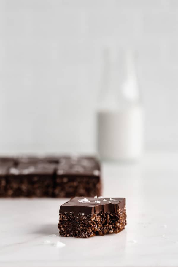 a rice Krispie treat on a counter with a bottle of milk in the background