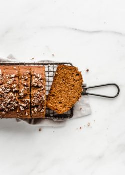 a pumpkin bread sliced on a cooling rack